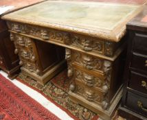 A late Victorian Gothic Revival knee hole desk,