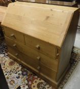 A modern pine bureau with fitted interior over two short and two long drawers and an early 20th