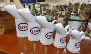 A graduated set of five modern Esso oil cans