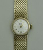 A ladies 9 carat gold cased "Record Deluxe" wristwatch with Arabic numerals and gold mesh strap,