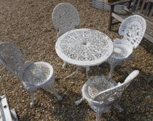 A painted cast metal garden table table and four chairs