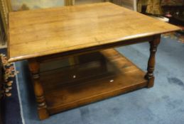 A modern oak two tier coffee table in the 18th century style