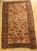 A Persian carpet, the central set with stylized birds and floral motifs on a fawn coloured ground,