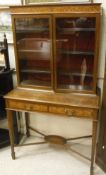 A Edwardian mahogany and inlaid Sheraton Revival style cabinet with two glazed doors over a single