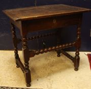 A 18th Century oak side table the plank top with cleated ends over a single drawer on bobbin turned