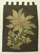 A needle work panel depicting floral spray on a modern brown ground