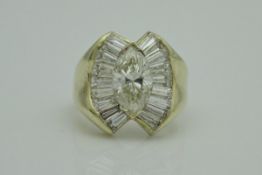 An 18 carat gold diamond ring, the central marquise shaped diamond approx 1.
