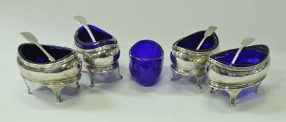 A set of four Regency silver oval open salts with cabriole legs and Bristol blue liners,
