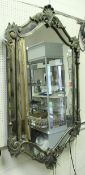 A large metal framed seven section mirror with scroll work decoration