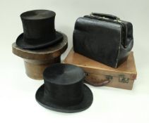 A black silk top hat inscribed "G.A.