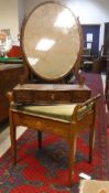 A 19th Century mahogany serpentine three drawer toilet mirror with oval plate with a Victorian
