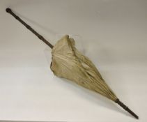 A circa 1900 silk parasol with carved wooden handle