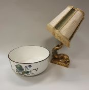 A gilt dolphin table lamp, a Villeroy & Boch Botanica fruit bowl,