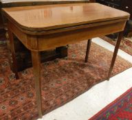 A 19th Century mahogany and inlaid rounded rectangular fold over tea table on square tapered legs