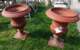 A pair of terracotta garden urns