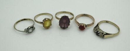 A collection of five 9 carat gold stone set dress rings
