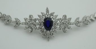 An 18 carat white gold bracelet set with central pear shaped sapphire surrounded by diamond