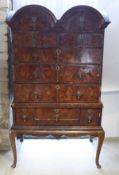 An 18th Century figured walnut veneered and feather banded chest on stand in three sections,