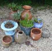 A collection of garden pots to include a pair of terracotta glazed urns,