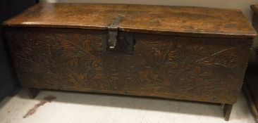 An 18th Century oak coffer, the one piece plank top engraved "GG 1719",