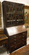 A George III mahogany bureau, the sloping fall opening to reveal a fitted interior,