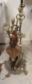 A brass stick stand decorated with recumbent dog and various fire irons, bellows,