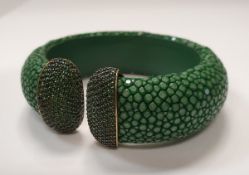 A modern shagreen silver mounted bangle set with green crystals to the finials