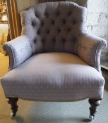 WITHDRAWN:A Victorian buttoned upholstered armchair on turned and ringed walnut supports to brass