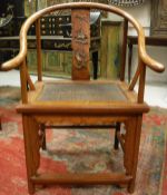 A pair of 20th Century Chinese elm and hardwood hall chairs with yoke back and relief work