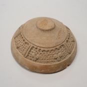 An early Islamic pottery bread stamp decorated with a band of panels with dotted and foliate