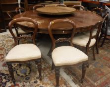A modern set of twelve dining chairs in the Victorian style together with a large circular dining
