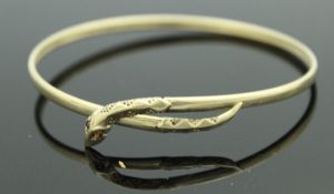 A 9 carat gold bangle with snakes head and tail decoration,