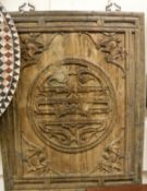 A 19th Century Chinese cherrywood and carved wall panel decorated with central medallion and bats