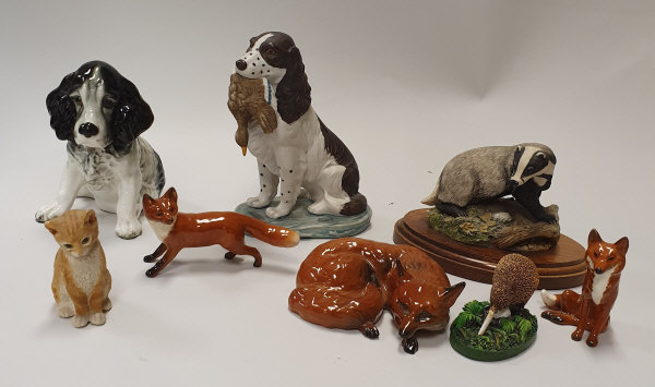 Three Beswick figures of foxes, one lying down, one seated, one standing,