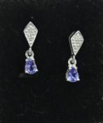 A pair of white gold tanzanite and diamond set earrings