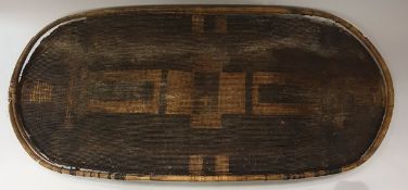 A late 19th Century African tribal basketwork warrior's shield decorated with geometric design,