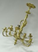 A twelve branch ormolu chandelier of scrolling acanthus design in the 18th Century Rococo taste