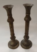 A pair of early to mid 20th Century Persian pierced and engraved brass candle holders