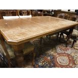 A Victorian oak extending dining table with extra leaf raised on ringed and turned supports
