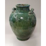 A 19th Century Chinese mottled green glazed vase with relief work bamboo decoration and handles