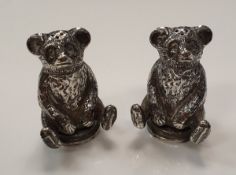 A pair of Edwardian silver pepperettes in the form of seated bears (Crisford & Norris Ltd,