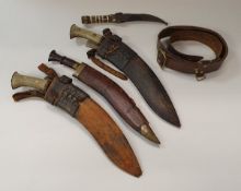 A Middle Eastern horn and bone handled dagger with curved blade and decorative metal bound and