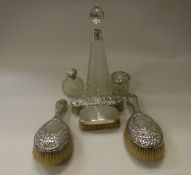 A box containing a cut glass and silver mounted grenade scent bottle, a large dressing table bottle,