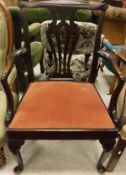 A late 19th Century elbow chair in the Chippendale taste, raised on cabriole legs and bun feet,