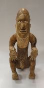 A Bembe (Democratic Republic of Congo) carved wooden "Mukuya" figure as a tribal chieftan holding