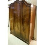 A figured mahogany three door wardrobe in the 18th Century manner and a matching tallboy