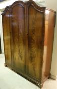 A figured mahogany three door wardrobe in the 18th Century manner and a matching tallboy