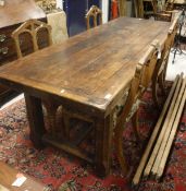 A oak refectory style dining table the plank top above H stretcher base together with a set of four