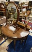 A Victorian mahogany and cross banded demi-lune card table the top opening to reveal a baize lined