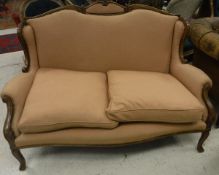 An Edwardian style two seat show frame sofa with peach upholstery